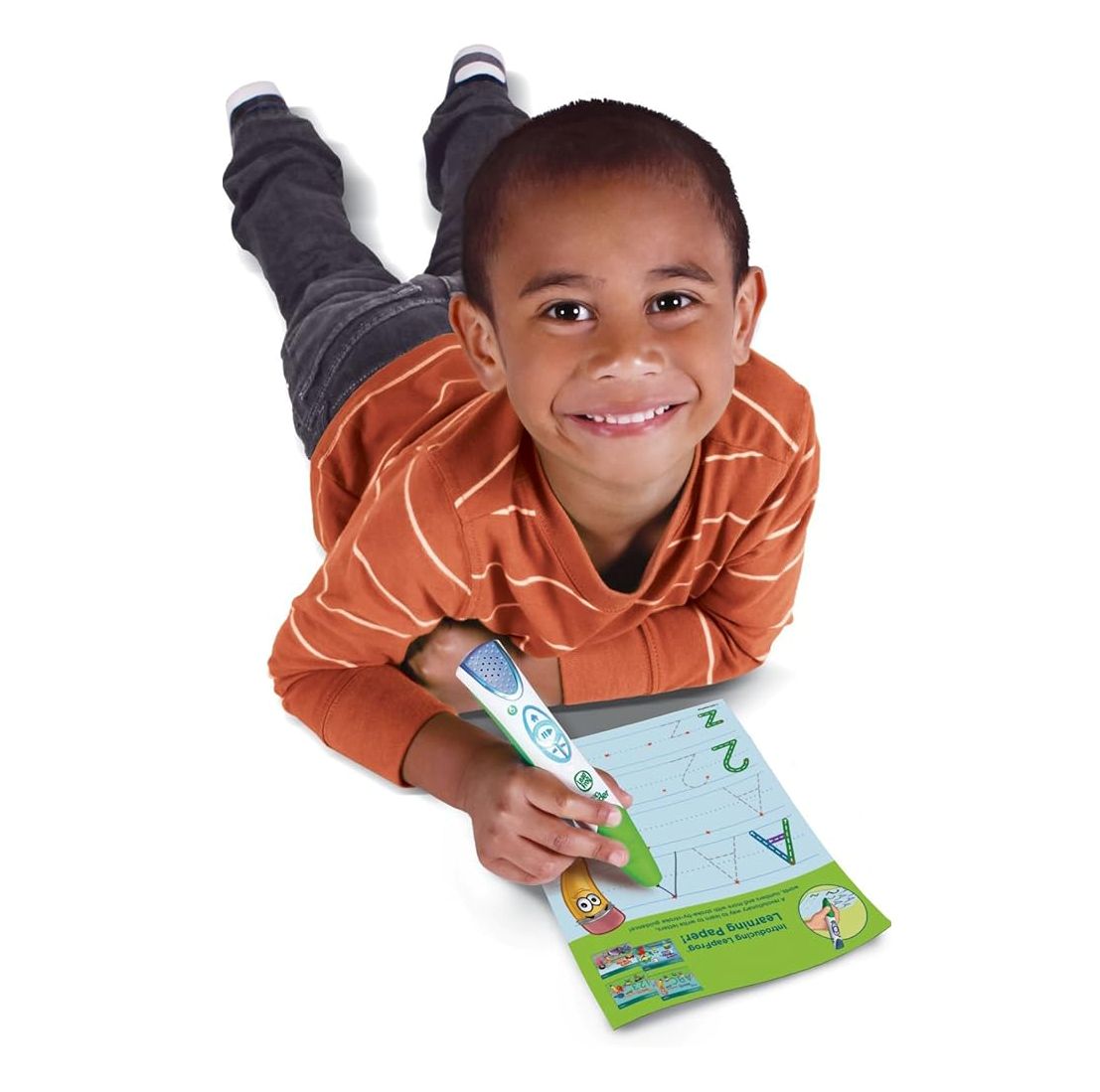 Child lying on a white surface with a coloring book and crayons