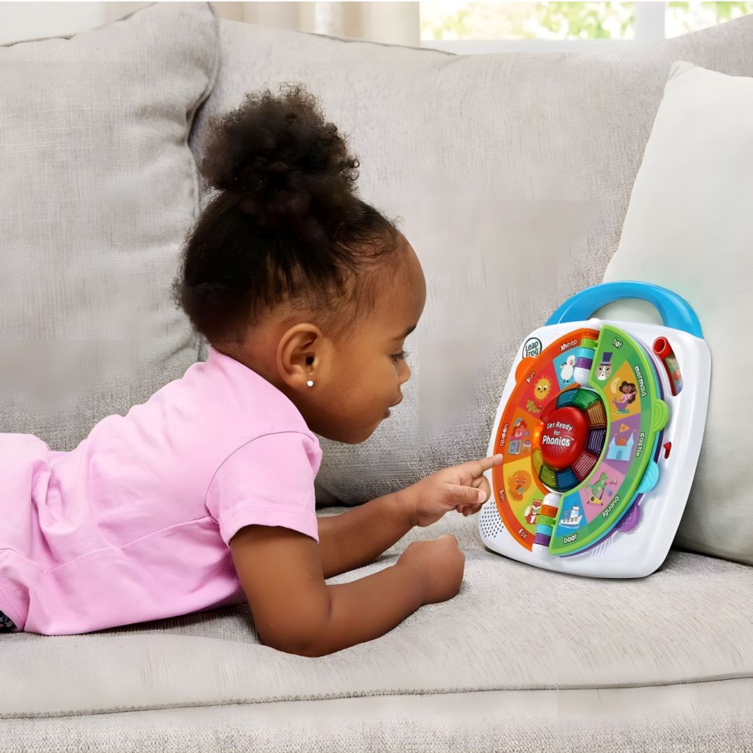 Child playing with a colorful toy on a couch